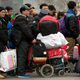 Waiting in line for ticket checks and security screening outside of the Beijing Railway Station.
